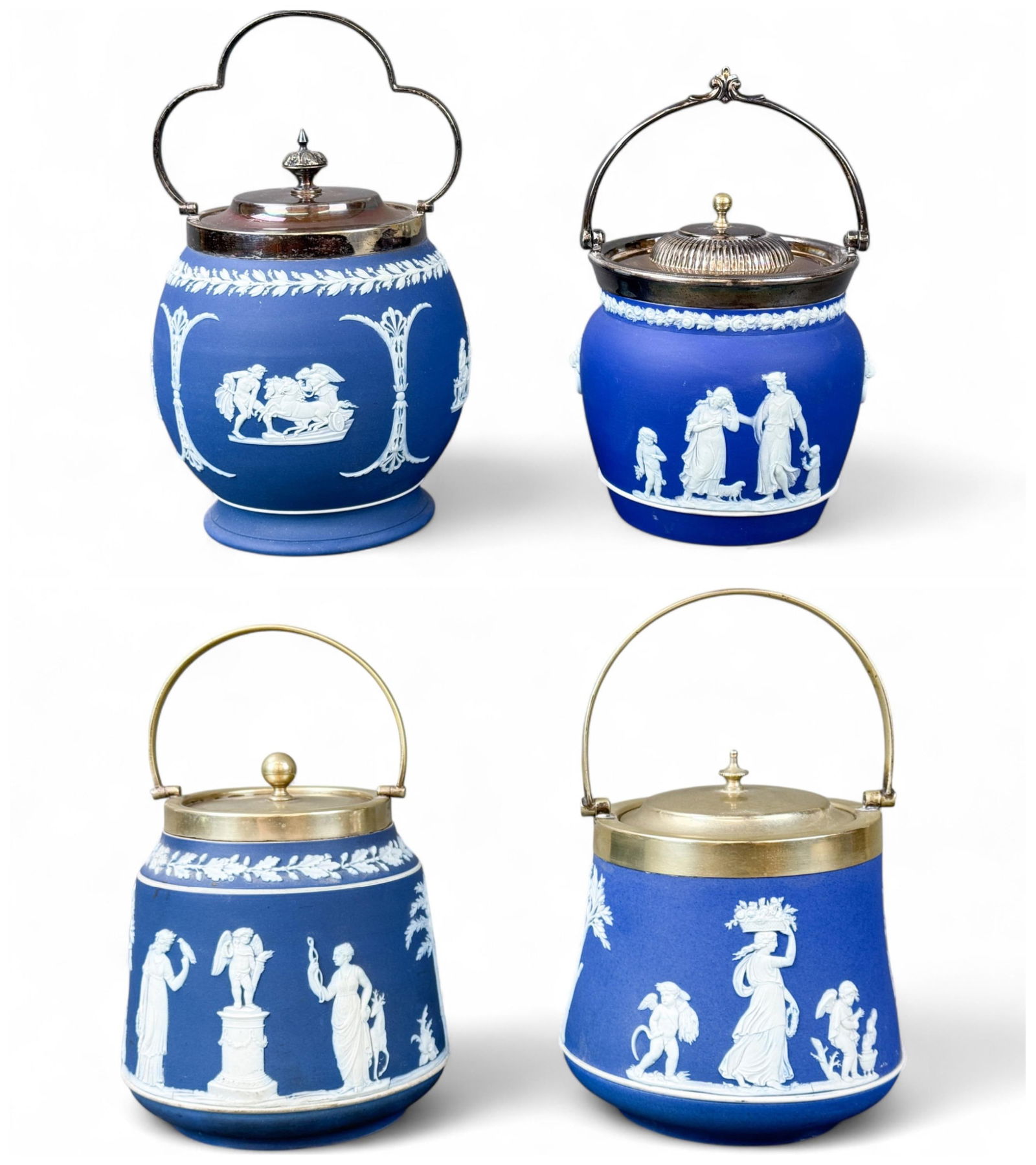 4 Wedgwood Jasperware biscuit jars.: A group of four Wedgwood Jasperware blue biscuit jars with silverplate lids. Late 19th century. Marked "WEDGWOOD" on bottom. Smallest: 5 1/2" x 5 1/2". Largest: 9 3/4" x 6". Condition: Surface dirt, r