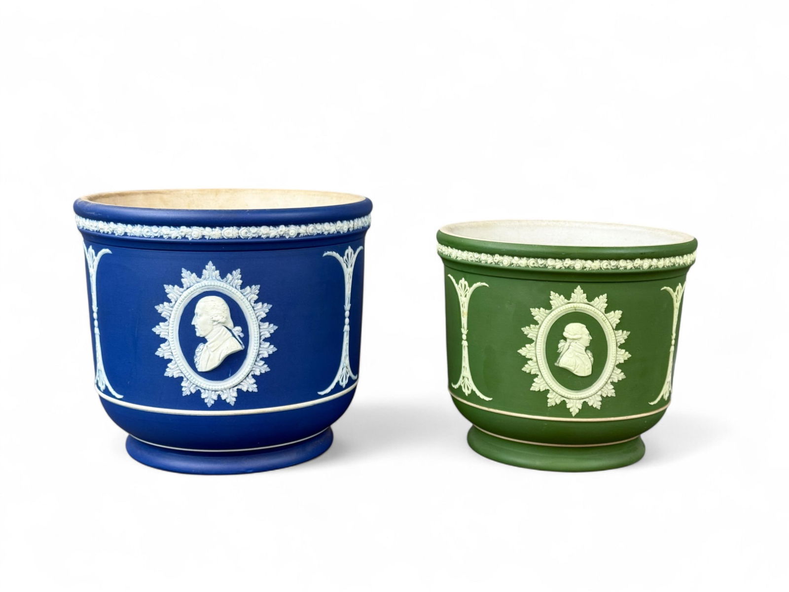 2 Wedgwood Jasperware "Founding Fathers" cachepots: A group of two Wedgwood Jasperware Founding Fathers cachepots. Both marked "WEDGWOOD/ ENGLAND." Discoloration in bowl. 7 1/4" x 8 1/4" and 6 1/4" x 7". Condition: Discoloration and staining in bowl.