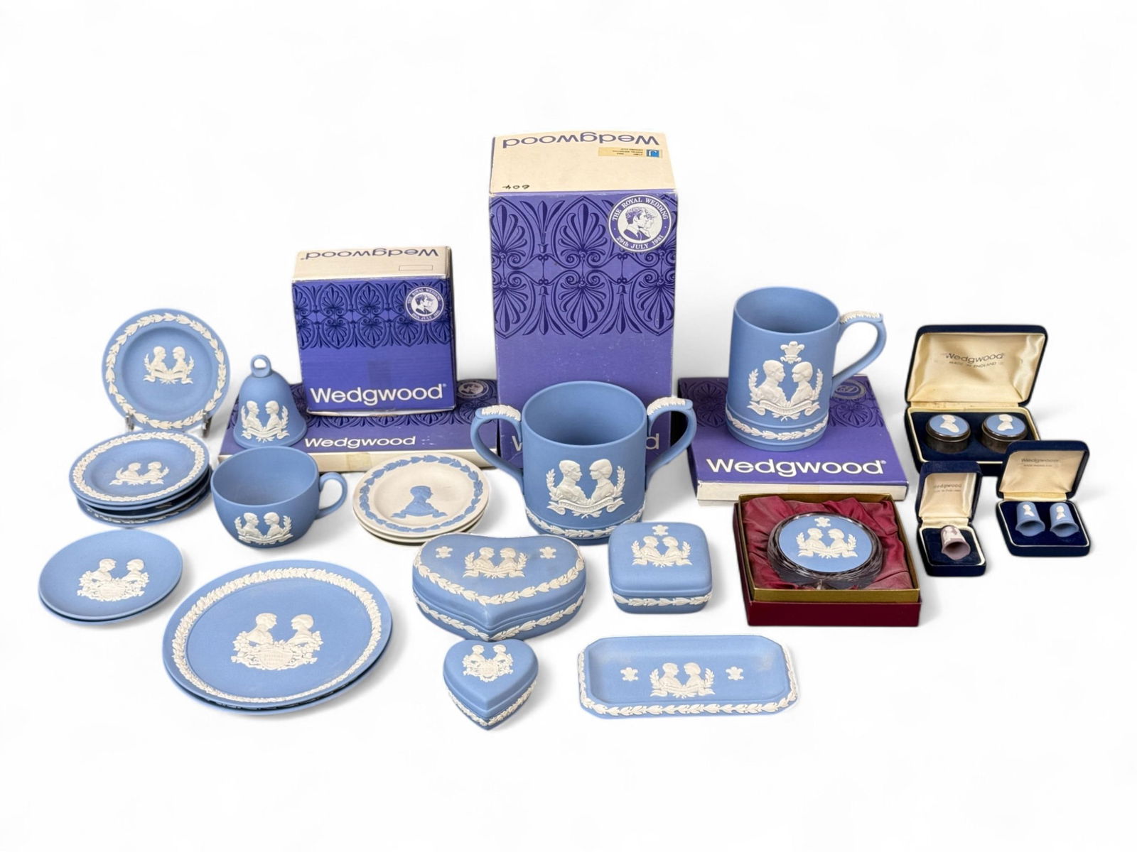 24 Wedgwood Prince Charles & Princess Diana pieces: A group of twenty-four Wedgwood Jasperware Prince Charles and Princess Diana Royal Wedding 1981, Royal Birth 1982/1984, and Royal Visit 1983 pieces. Includes boxes for 3645 heart box, 3642/3 round tra