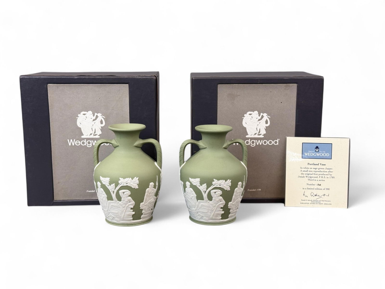 2 1994 Wedgwood LE Portland Vases in box.: A group of two 1994 Wedgwood Limited Edition Green Jasperware Portland Vases in box. One includes COA. One signed on base by Lord Baltimore. 5 3/4" x 4 1/2". Box: 6 5/8" x 6 1/2". Condition: Foam disi