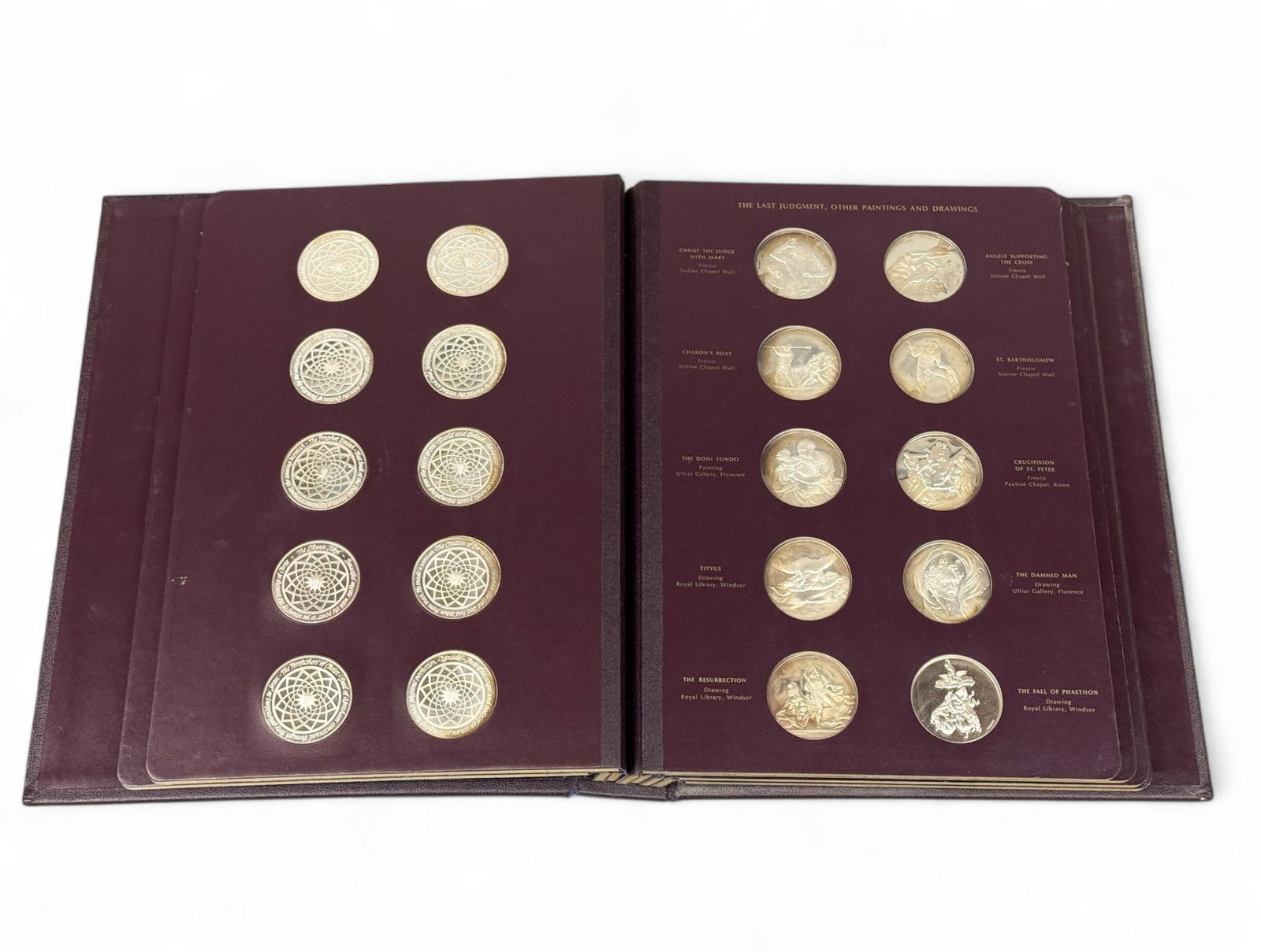 Franklin Mint "The Genius of Michaelangelo.": A 1976 Franklin Mint "The Genius of Michaelangelo" complete set of sixty sterling medallions in leather bound folio. 75.5 ozt total. 13 1/2" x 10 3/8" x 2". Condition: Damage to cover.