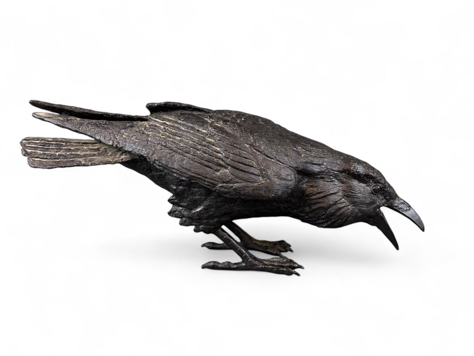 Jim Eppler, Raven, Bronze.: Eppler, Jim (American, b. 1950). Bronze raven sculpture. "VII B." Signed and editioned on lower leg. 9 1/2" x 23 1/2" x 8".