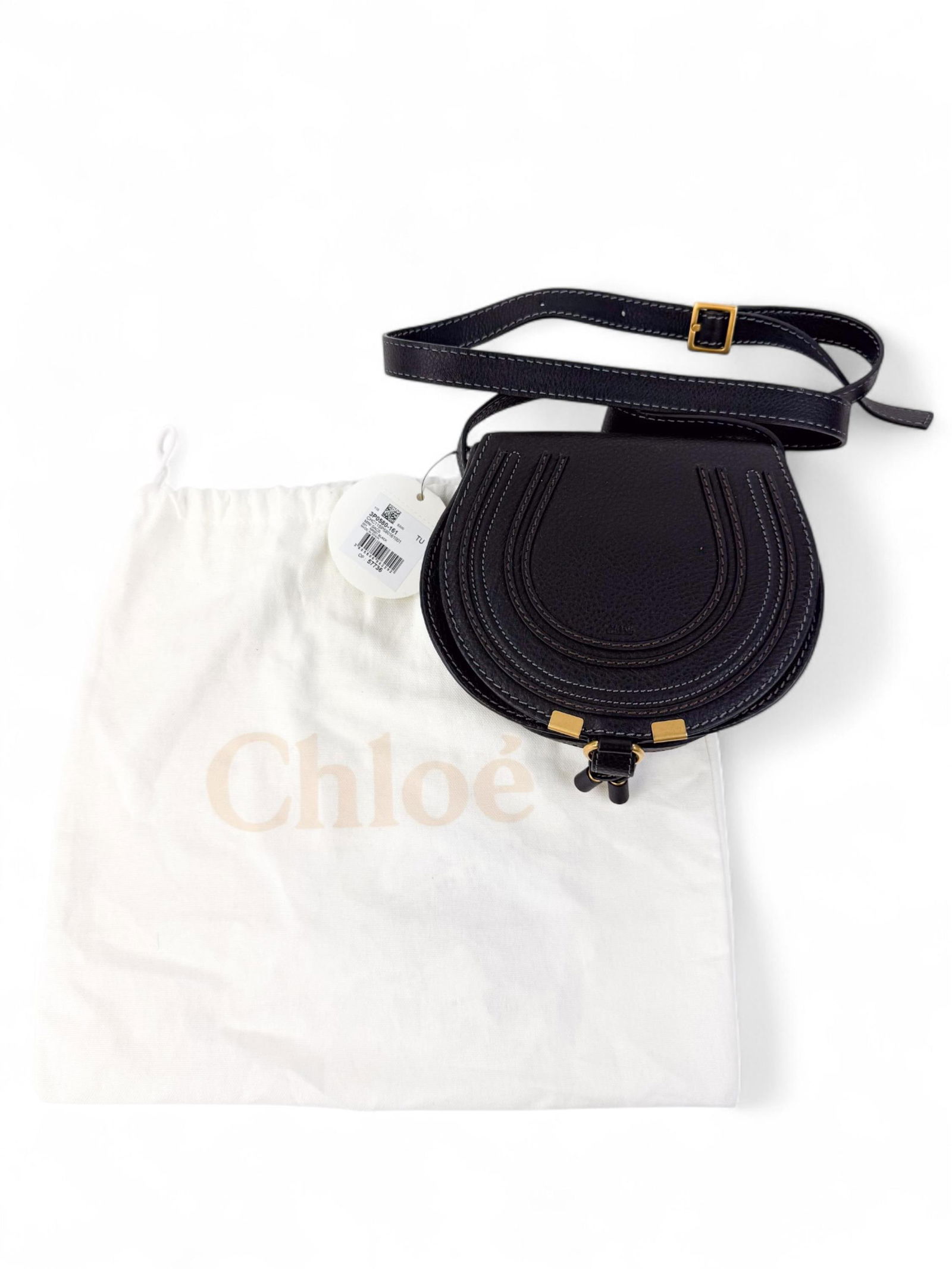Chloe Marcie saddle bag.: A black Chloe Marcie grained leather saddle bag with stitched detail, flap front, and gold-tone hardware. Includes dust bag. Condition: Excellent.