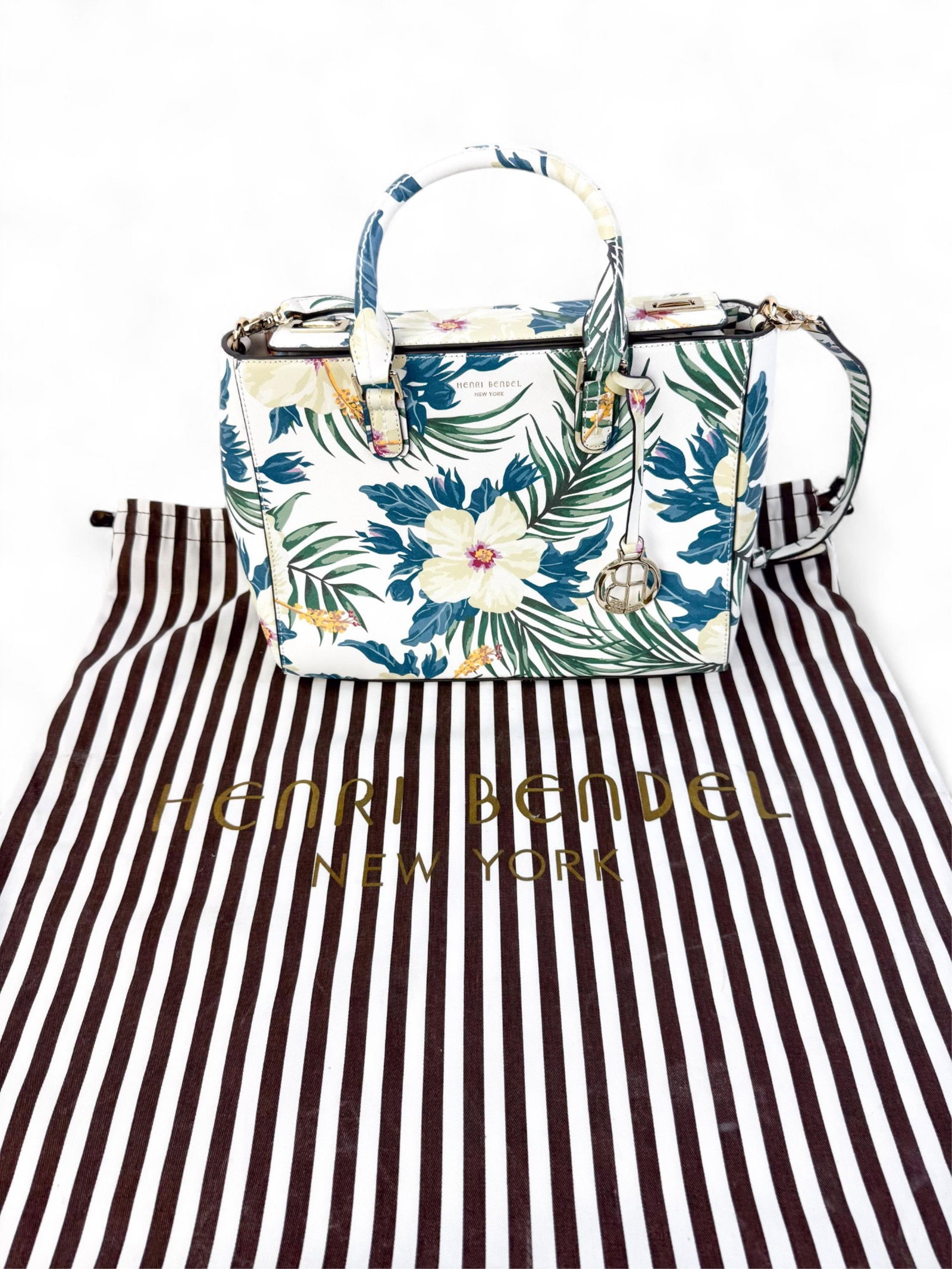 Henri Bendel tropical print tote bag.: A Henri Bendel tote in canvas with colorful tropical print, leather trim, and shoulder straps.