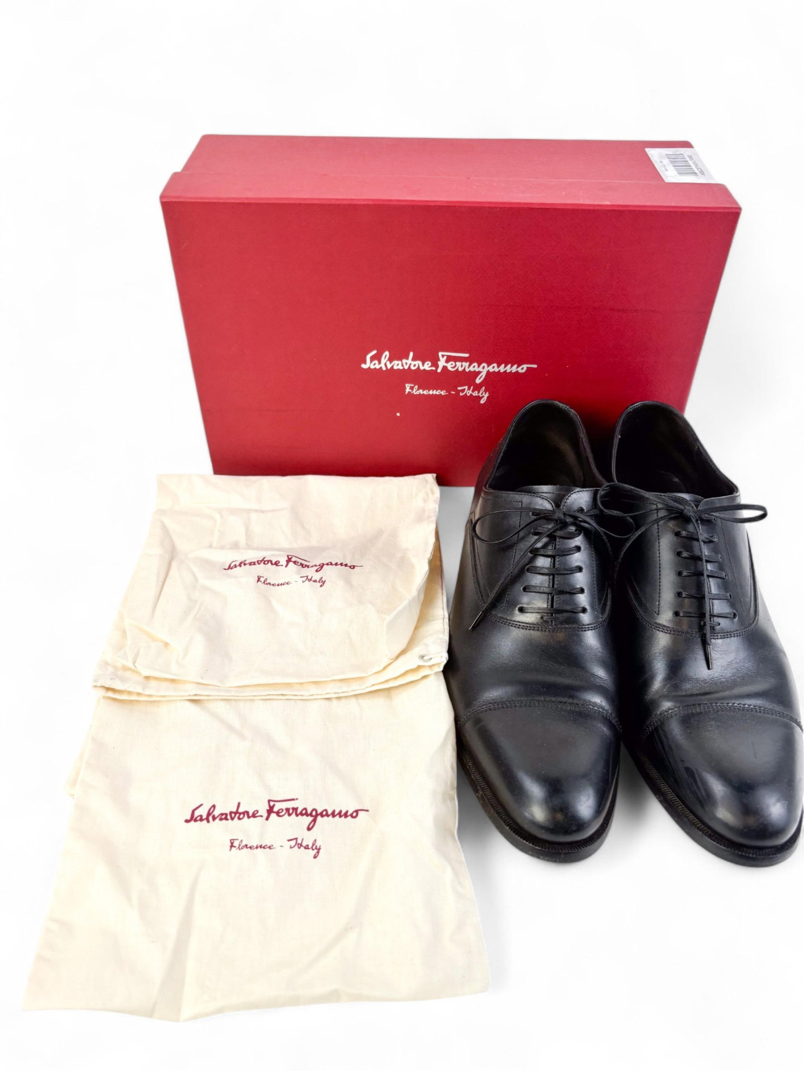 Salvatore Ferragamo men's dress shoes.: A pair of Salvatore Ferragamo men’s dress shoes in black polished leather with lace-up closure. Includes original box.