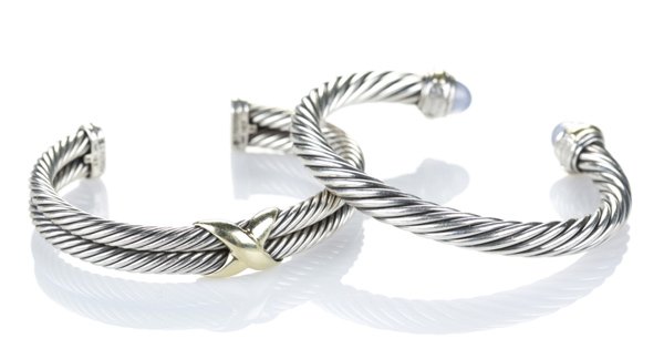 2 David Yurman sterling silver and gold bangles.: A pair of two David Yurman sterling silver and gold bangle bracelets. One set with light colored blue purple stone. 2 3/4"w. 7/8" opening. 2.835 t ozs.
