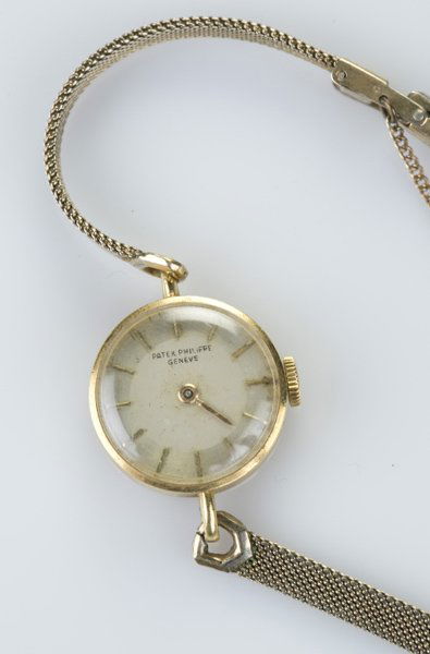 A Patek Philippe Geneve gold ladies watch: A Patek Philippe Geneve 18 KT gold ladies watch. c. 1950s. Band is not original. Face: 3/4"diam. 0.455 t ozs.