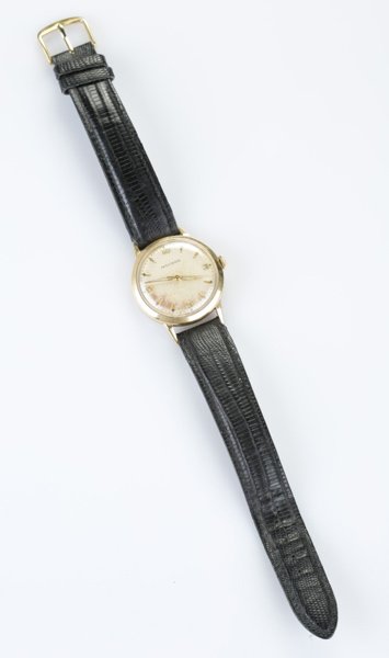 Movado 14 KT men's wrist watch with leather band: A Movado men's wrist watch with a leather band. 14 KT gold. Engraved on back, "RWB Aug. 25, 1956". Face: 1 1/4"diam. Band: 9 1/4"l.