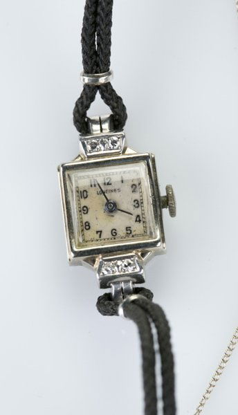 Longines square 14 KT watch w/ 4 diamonds: A Longines square ladies 14 KT white gold watch with four diamonds. Face: 1/2"l x 1/2"w. 0.35 t ozs.