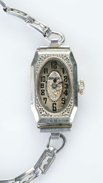 A Gruen lady's watch, 14 KT white gold: A Gruen silver ladies watch. Long octagonal face with central floral motif. 14 KT white gold. Engraved, "Donna" on reverse. Face: 1"l x 3/4"w. 0.56 t ozs.