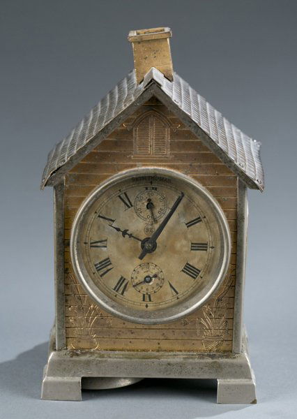 Seth Thomas copper mantle clock: A Seth Thomas copper mantle clock shaped like a house. Late 19th/early 20th century. With glass windows at sides. Works etched with ST. 7 1/4"h x 4 1/4"w x 3 1/4"d.