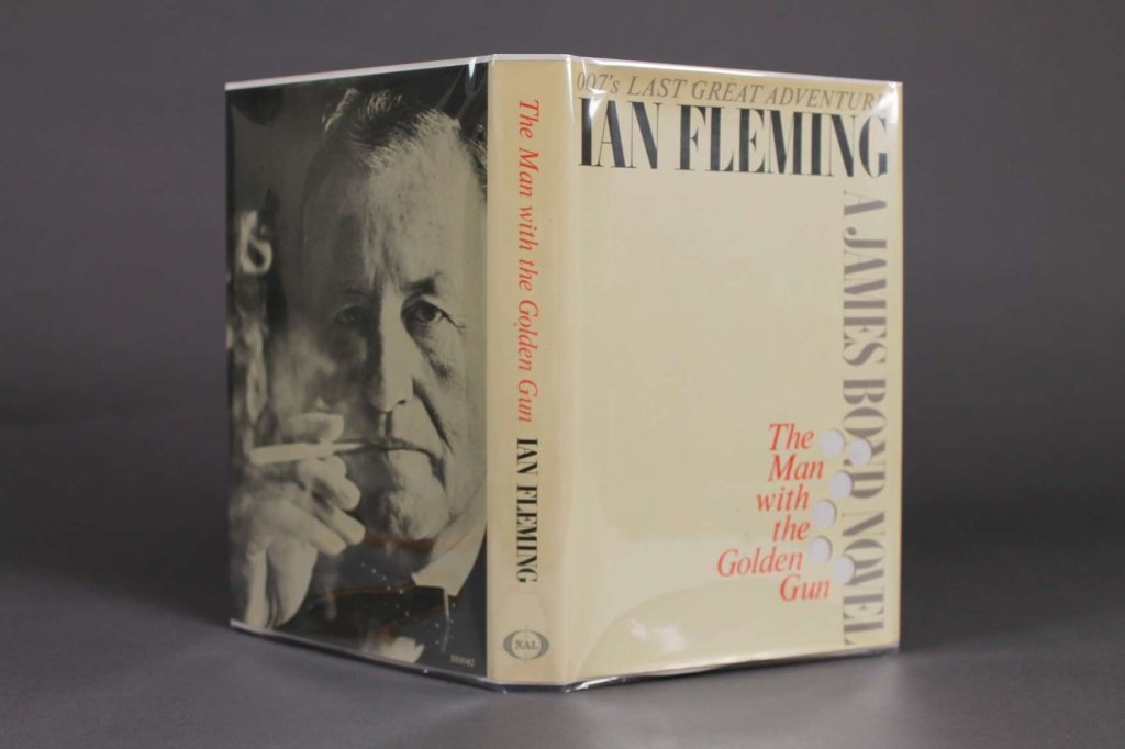 Ian Fleming. 007'S LAST GREAT ADVENTURE. (1965).: [Fleming, Ian]. THE MAN WITH THE GOLDEN GUN. New American Library, (1965). 8vo. Black paper-covered boards with golden gun embossed on spine and front cover, red lettering on spine. Near fine in brigh