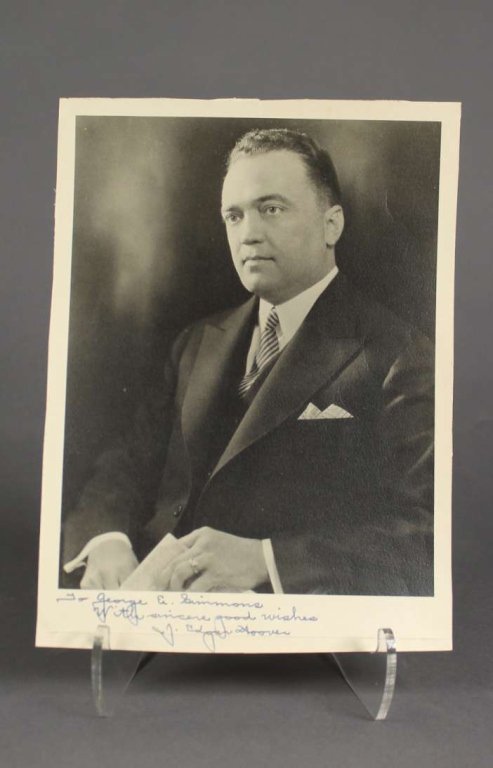 J. Edgar Hoover. Signed and inscribed photograph.: [FBI]. J. Edgar Hoover. Signed & Inscribed Photograph. 4to, formal portrait, inscribed below the image: “To George E. Simmons With sincere good wishes J. Edgar Hoover” . Horizontal crease at lower