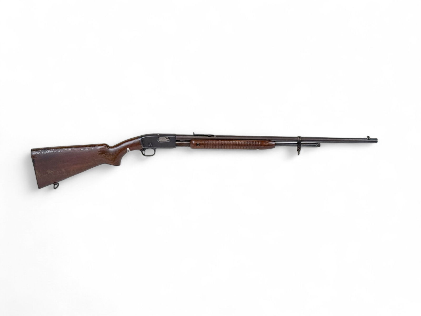 Remington Fieldmaster M121 rifle, .22 cal: [Modern Firearm] A Remington The Fieldmaster Model 121 slide action rifle, .22 S, L, or LR. Blued finish. 24" barrel with open sights. Walnut semi pistol and fore stock. Serial 461**. 42" overall. Con