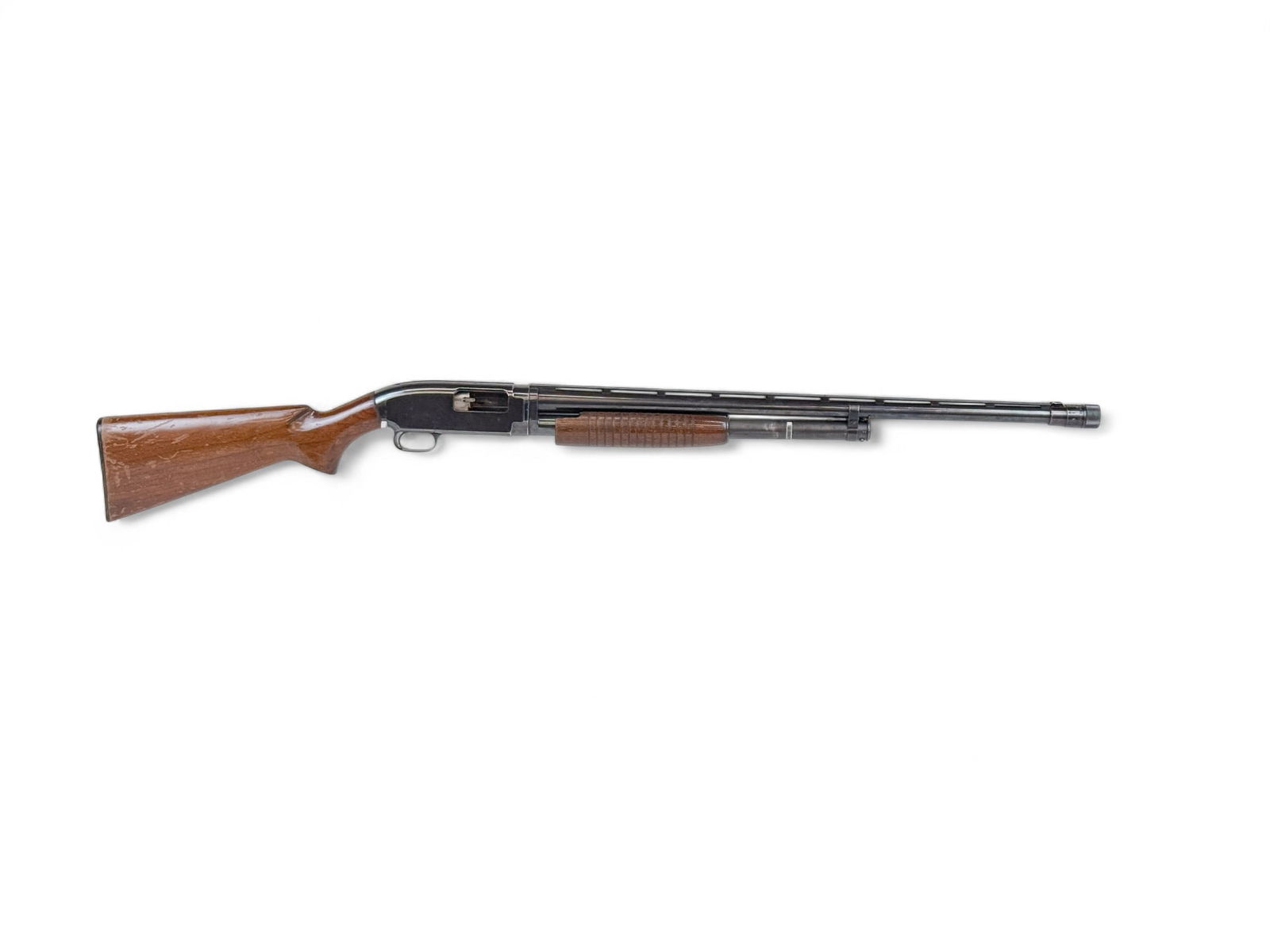 Winchester M12 slide action shotgun, 12 gauge: [Modern Firearm] A 1954 Winchester Model 12 slide action shotgun, 12 gauge. Blued finish. 26" ribbed vent barrel and super Polychoke. Walnut semi pistol grip stock and fore stock. 14" length of pull.