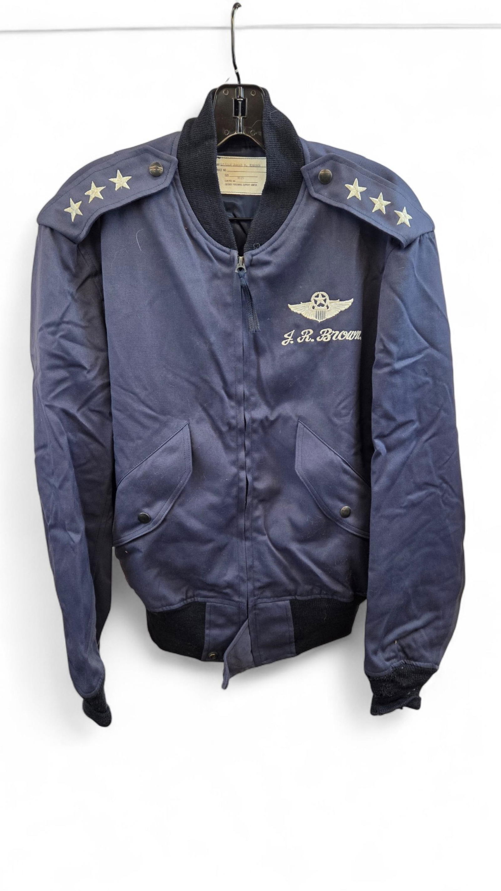 Gen. Brown flight jacket: A USAF Lt. Gen. James R. Brown (1930-2015) flight jacket. Lt.. General rank insignia epaulettes. Embroidered Command Pilot wings over J.R. Brown. Label with name on inside. Provenance: From the Estate