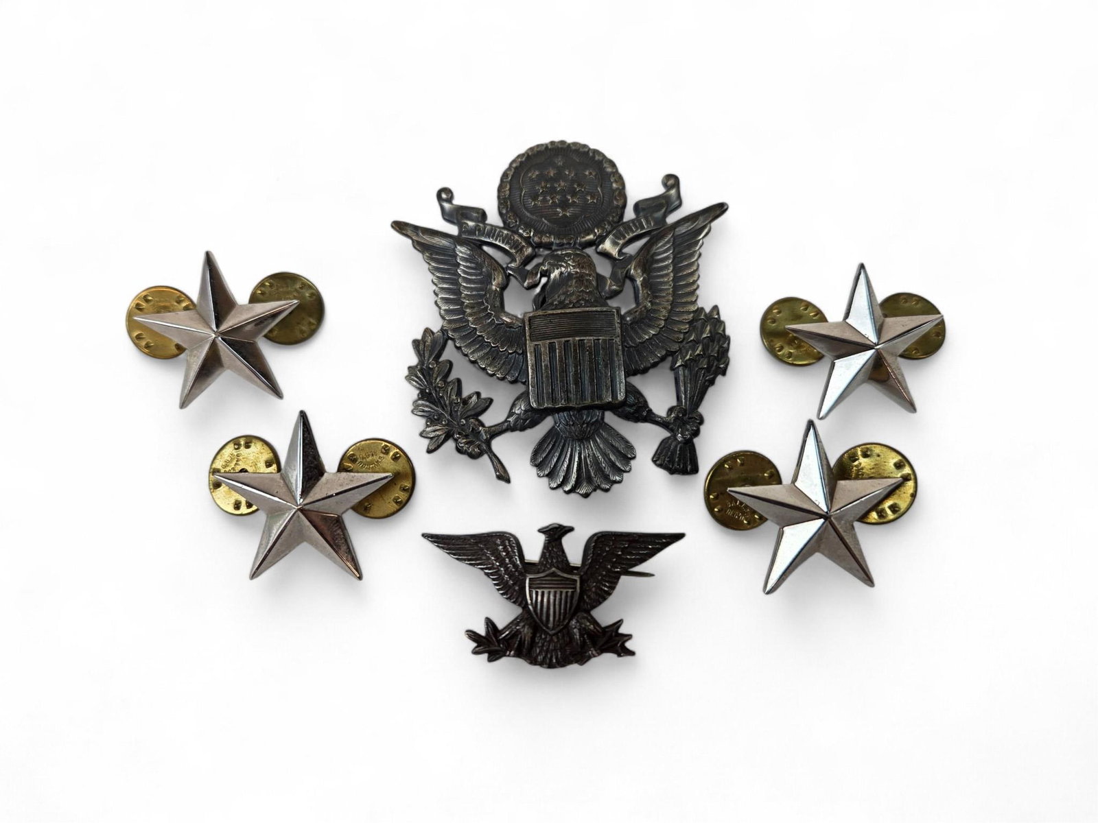 6 Gen. Shores insignia: A group of six U.S.A.F. Brigadier General Von R. Shores (American, 1912-1974) insignia. Including pin back sterling Colonel rank insignia, four N.S. Meyer Inc. clutch back sterling General star insign