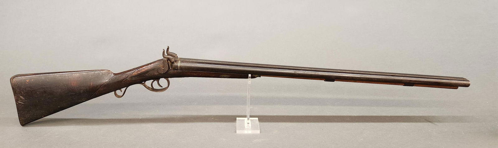 Percussion sxs shotgun, 12 Gauge: [Antique Firearm] A percussion side by side back action shotgun, 12 Gauge. 31" barrel marked "REAL TWIST." Walnut straight wrist stock. Includes ramrod. 48" overall. Condition: Fair condition. Dark pa