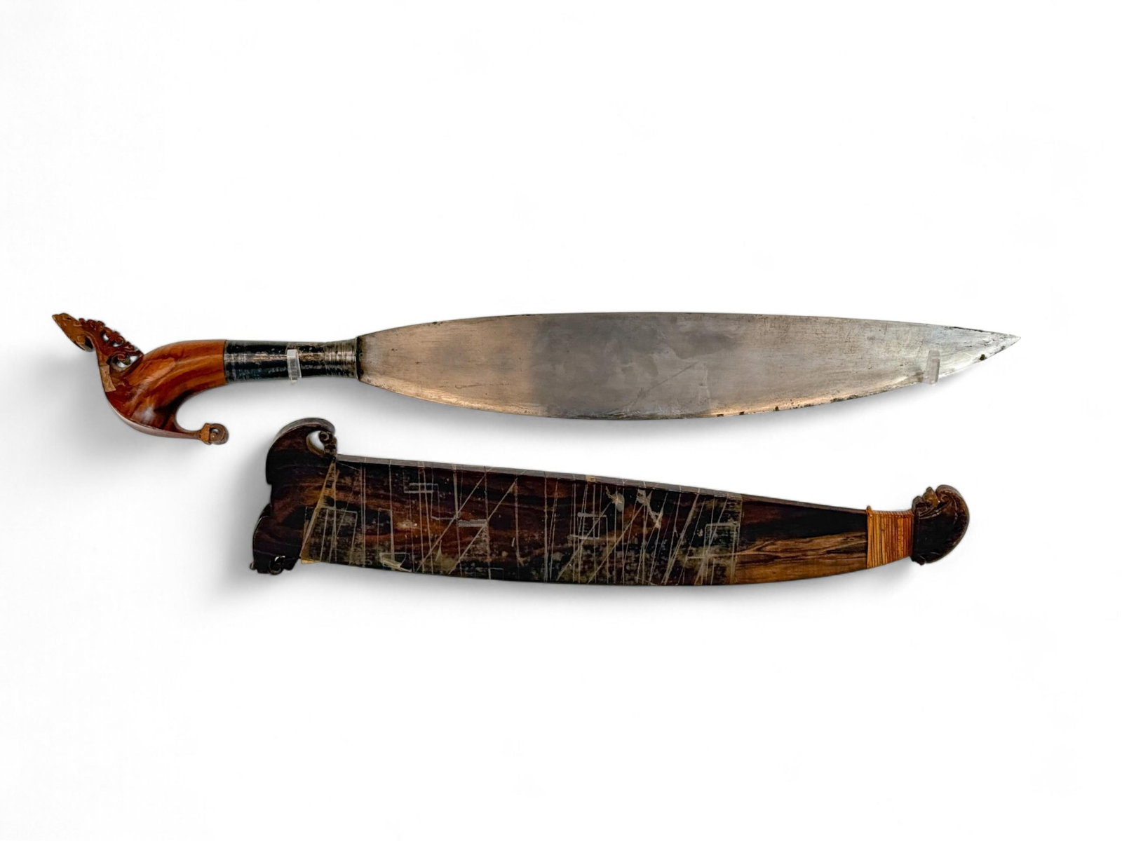Filipino Moro Barong with scabbard.: A Filipino Moro Barong with scabbard. Heavily carved grip and silver ferrule. 17" blade. 18" wood scabbard. 25" overall. Condition: Scabbard wrapped in scotch tape.