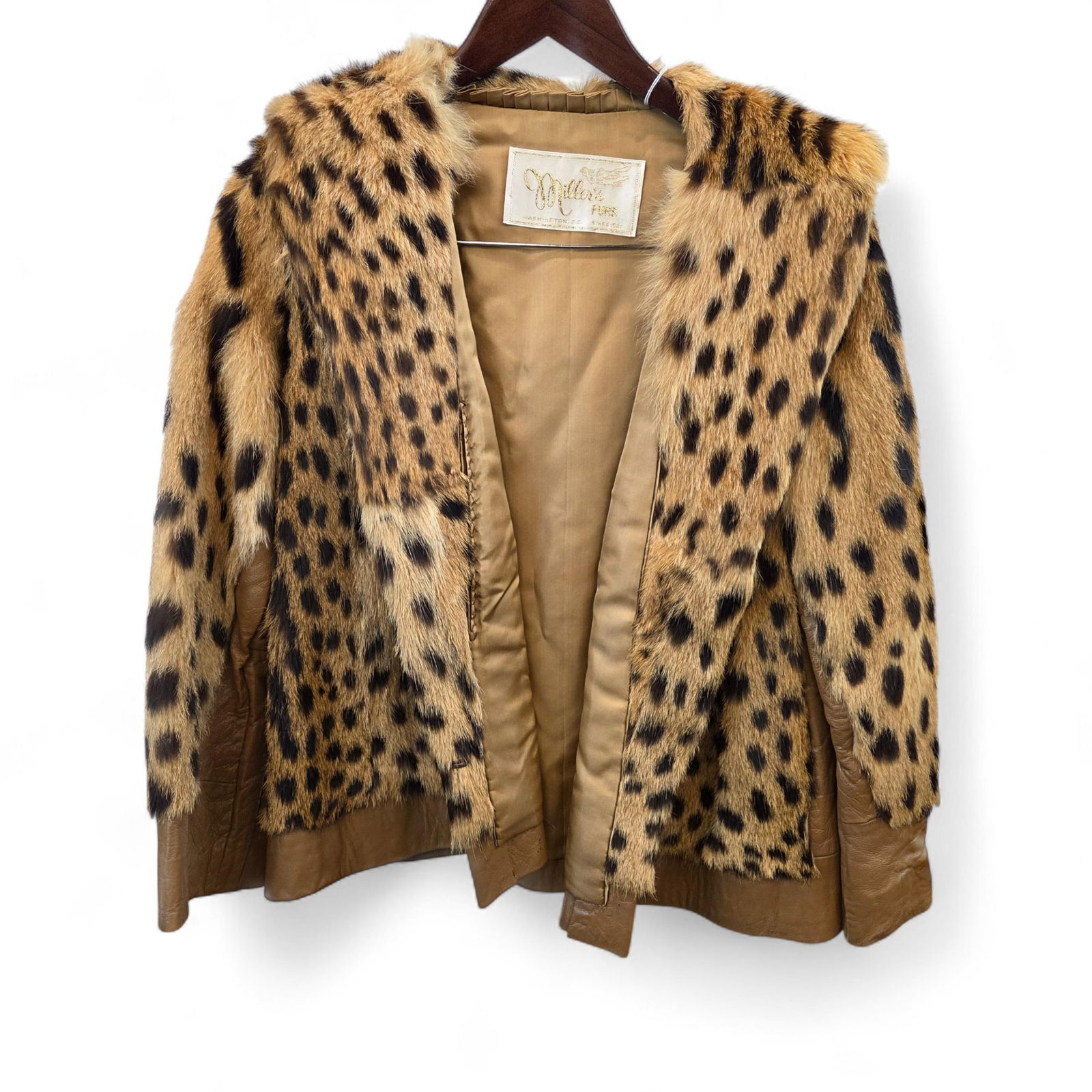Cheetah fur and leather coat VA BUYERS ONLY: *VIRGINIA BUYERS ONLY* A Miller's Fur, Washington D.C. Cheetah fur and leather coat. Name in embroidered inside. 25" long. 17 1/2" shoulder.