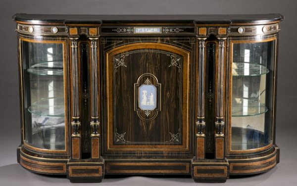 A large wood display case with glass sides: A rosewood and ebonized cabinet with inset jasoer plaques. 19th century. Central large door with plaque, flanked by pairs of reeded columns which are flanked by curved glass doors revealing cabinets w