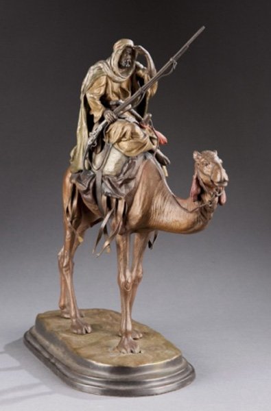 Bergman style Austrian painted bronze man on camel: A Franz Bergman style cold painted Austrian bronze. Late 19th/early 20th century. A man riding a camel, looking out over the horizon. Indecipherable mark on bottom.12 1/4"h exclusive of later base.Con