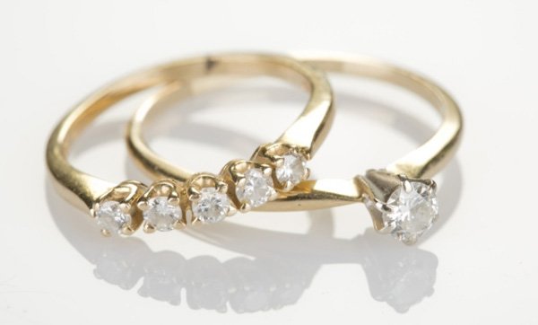 Diamond band and solitaire: A diamond band and solitaire. A small solitaire has a .25 CT diamond in 14KT yellow gold and 14KT yellow gold band has 5 small diamonds. Tw. 0.095 ozt.