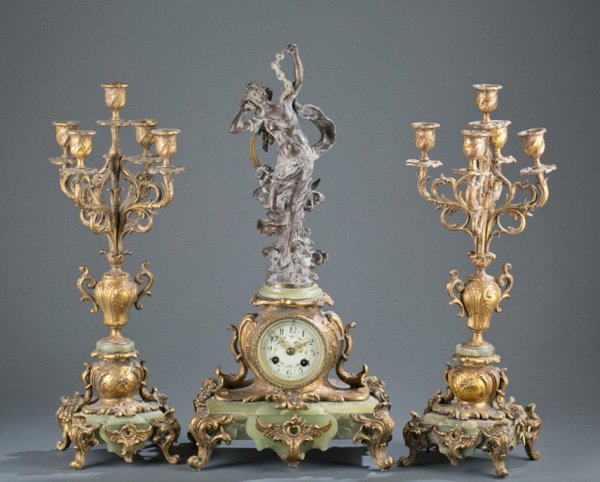 LF Moreau French bronze mantel clock set, 19th c.: A French bronze and green onyx mantel clock set. Last quarter 19th century. Bronze woman with roses entitled, "Nuit Del Mar" and signedon reverse, "Louis Moreau". On works, "Paris/3721". Clock, " 22 1