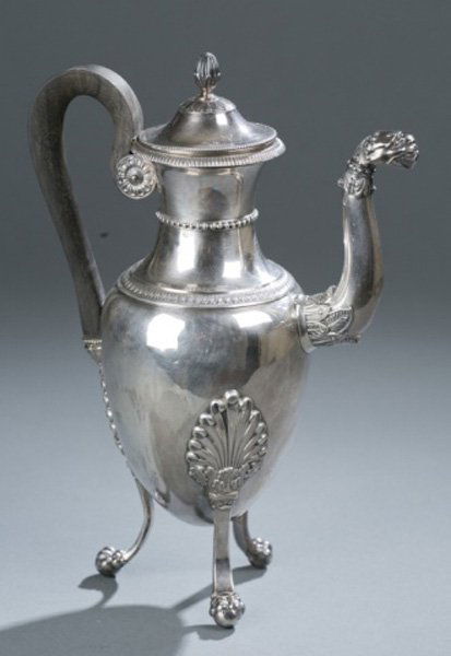 Sterling silver coffee pot with ebony handle: A sterling silver coffee pot with an ebony handle. With gadrooned, beaded, and shell details on three paw and ball feet. With stamped hallmarks. 10 1/2"h x 7 1/4"w x 4"d. 14.995 t ozs.