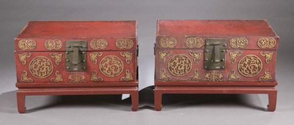 Japanese chests (2) lacquered: A pair of red painted wood Japanese chest and stands with metal latches and handles. Carved medallions meaning long life and happiness. 15"h x 39"w x 19"d. Condition: Fair.