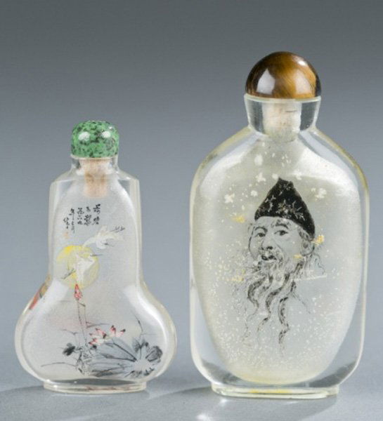 Group of 4 Inside Painted Chinese Snuff Bottles: A group of four Chinese inside painted snuff bottles. 20th century. ++ Crane and a woman with a spotted green hardstone top and no stick. 2" h. ++ Man's face and Chinese writing with brown hardstone t