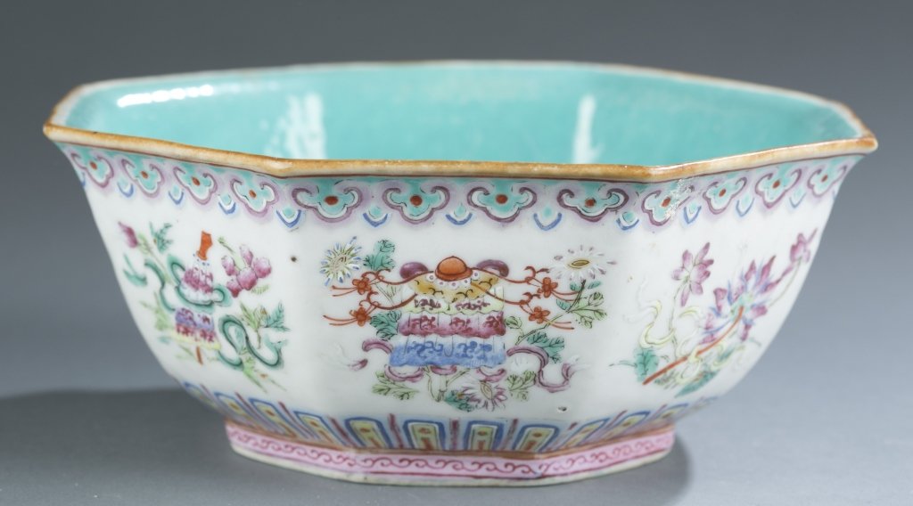 Chinese octagonal low bowl, painted, 19th/20th c.: A Chinese painted octagonal low bowl. 19th/early 20th century. Interior of bowl with light blue. Exterior depicts Buddhist symbols. 3"h x 7"w.
