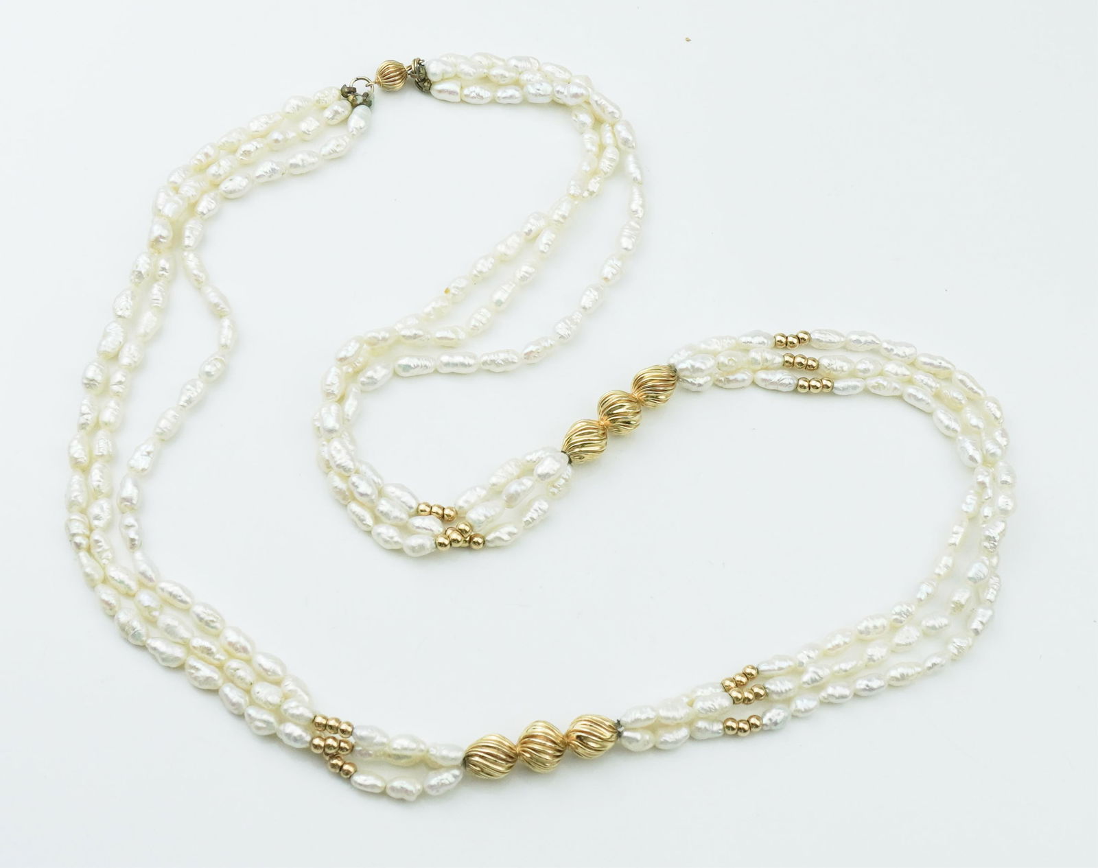 14KYG Fluted Bead & Rice Pearl Necklace: 14KYG Fluted Bead & Rice Pearl Necklace aspprox. 24.0 inches with three strands, tested 14K yellow gold