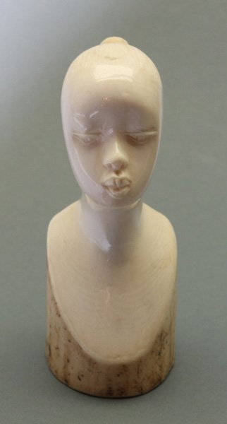 African ivory carved female bust.: Woman with hair in bun. Solid ivory. 4 1/2"h.