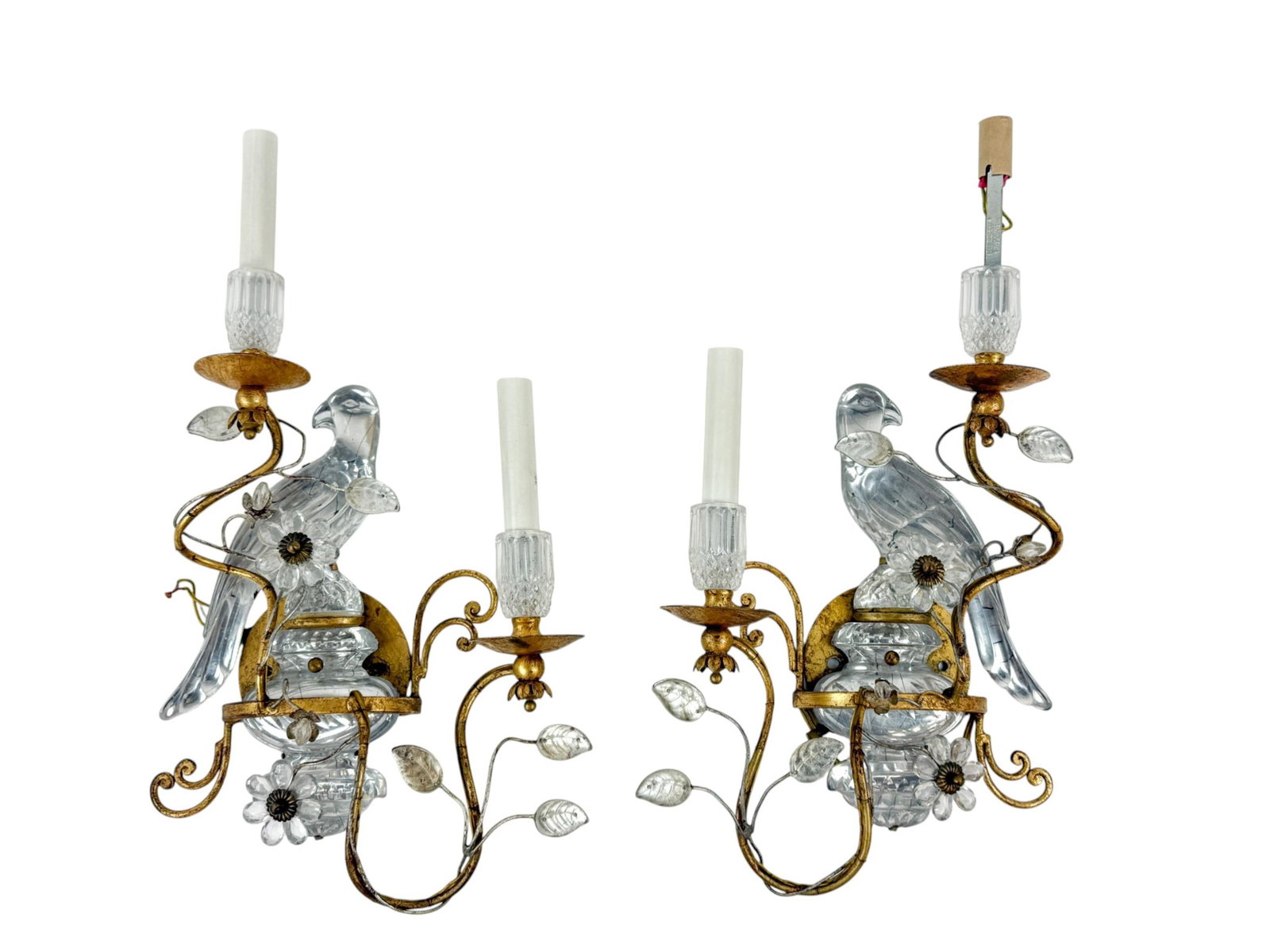 2 Bagues glass parrot sconces.: A pair of French gilt metal and glass two-light electrified wall sconces in the manner of Maison Bagu?s, each modeled with perched glass parrots amid scrolling foliate arms and floral sprays. The fram