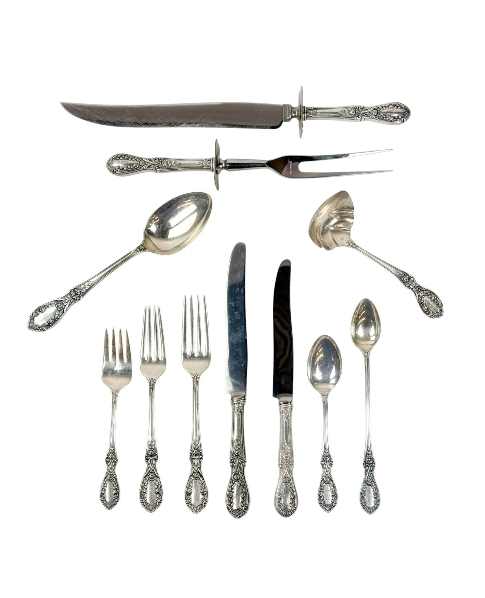 Manchester "American Beauty" sterling flatware set: A Manchester "American Beauty" sterling silver flatware set. Monogrammed. 72.72 ozt. Eighty-two pieces. Including twelve 7 3/8" forks, eight 7 1/4" forks, thirteen 6 1/8" salad forks, three 7 7/8" ser