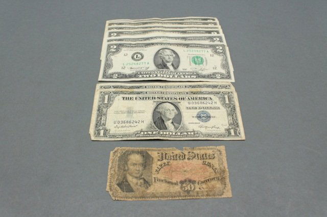Lot of US paper currency including: A lot of two silver certificates, Six green and red stamped two dollar bills, One fifty cent fractional currency.