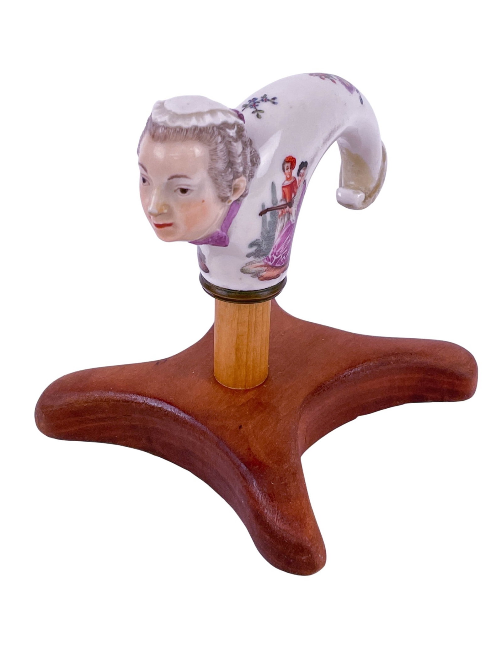 Porcelain cane handle.: A Meissen porcelain cane handle modeled after a lady's head with Watteau scenes. c. 1740. Hard paste porcelain, unmarked. With mount: 4 1/2" x 4". Provenance: Exhibited: The Luxury of Clay: Porcelain 