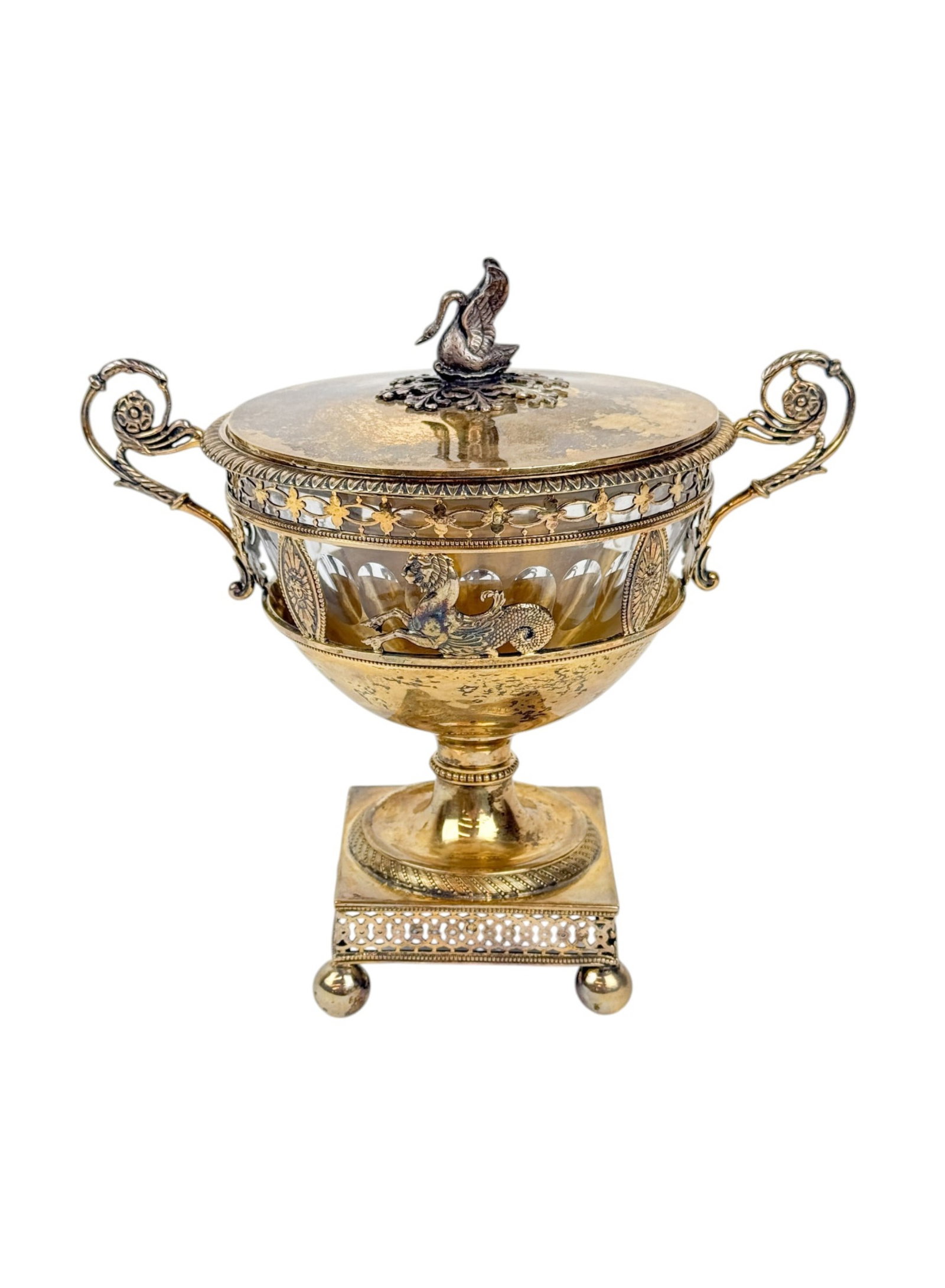French Restoration gilt silver drageoir.: A French Bourbon Restoration gilt silver drageoir with crystal insert. Circa 1819. Lid with swan finial. Floral handles with pierced classical form body with shields and Leocampus on pierced base