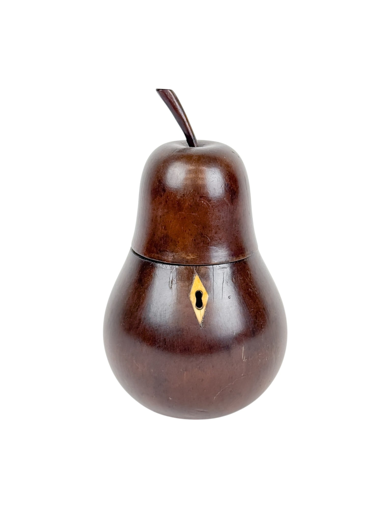 George III fruitwood pear tea caddy.: A George III stained fruitwood tea caddy in the shape of pear. With a carved wood stem and ivory escutcheon. Late 18th to early 19th century. 8" x 5".