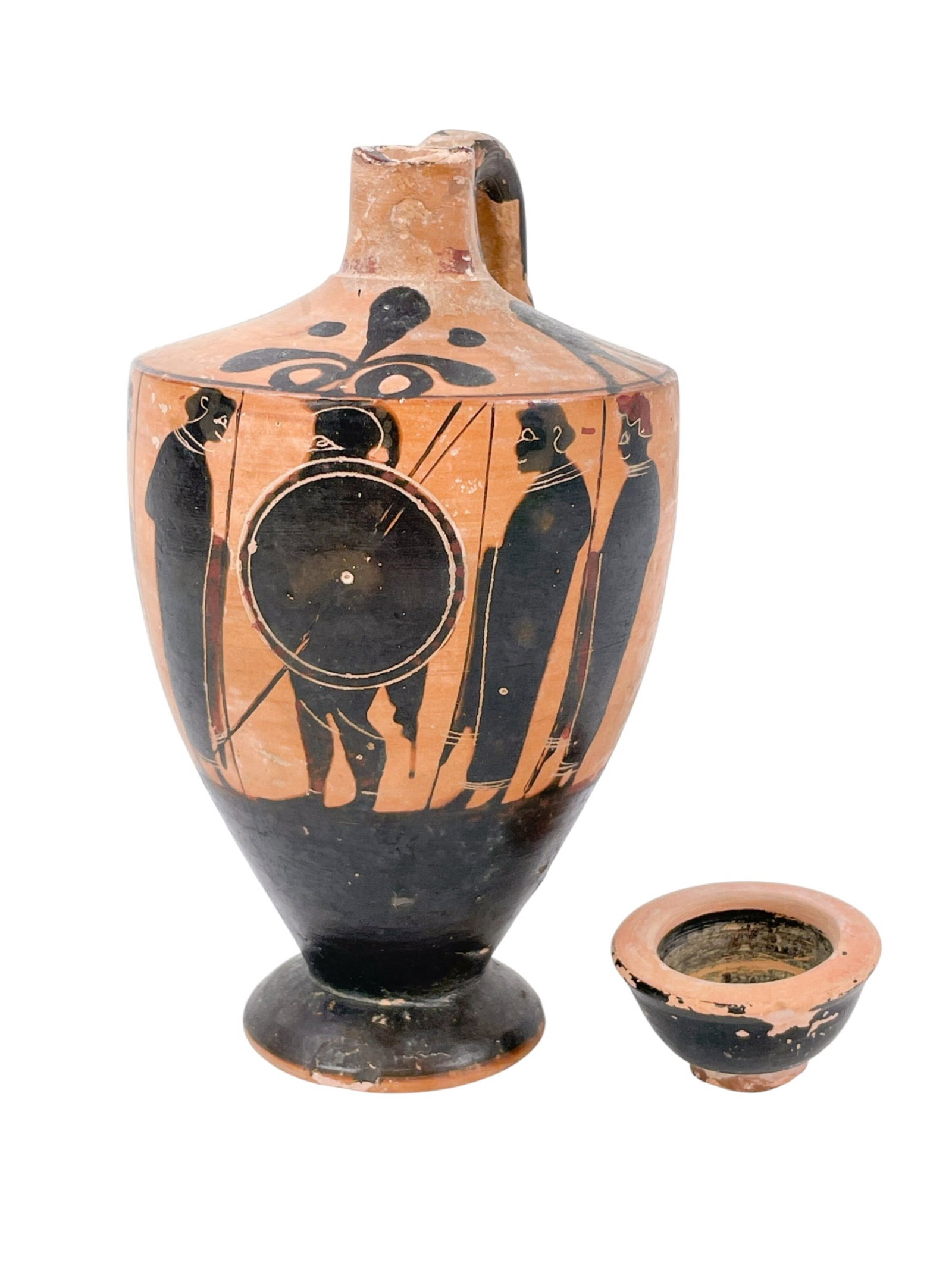 Greek Black-figure lekythos.: A black-figure lekythos (vessel for oil) with a scene of soldiers preparing for war. Possibly 6th century BCE. Greece. 5 3/4" x 3 1/4". Condition: Abrasions, pigment loss, gouges, chipped base, spout