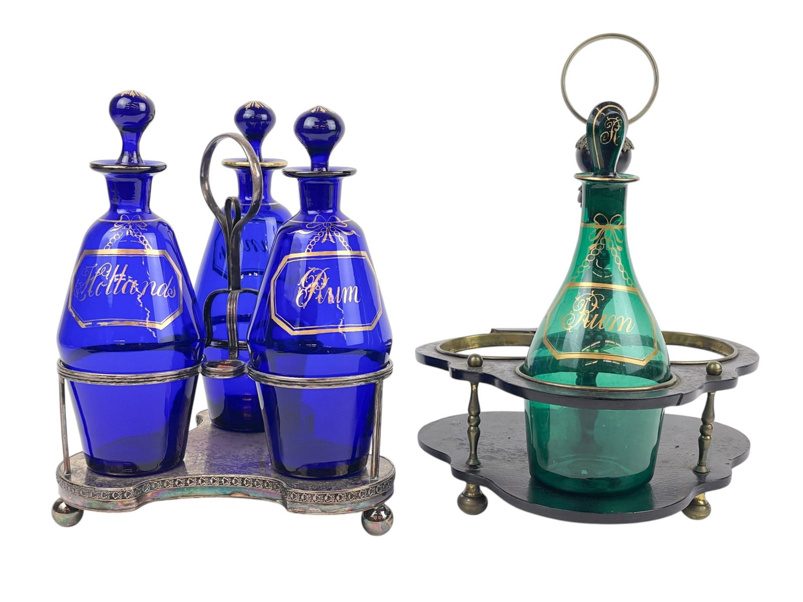 4 Decanters in silverplate and wood stands.: A group of Bristol blue decanters in silverplate stand and one decanter in wood and brass stand. 18th to 19th century. Smallest: 10 1/2" x 8". Largest: 12" x 8 1/2". Condition: Wooden stand is broken.