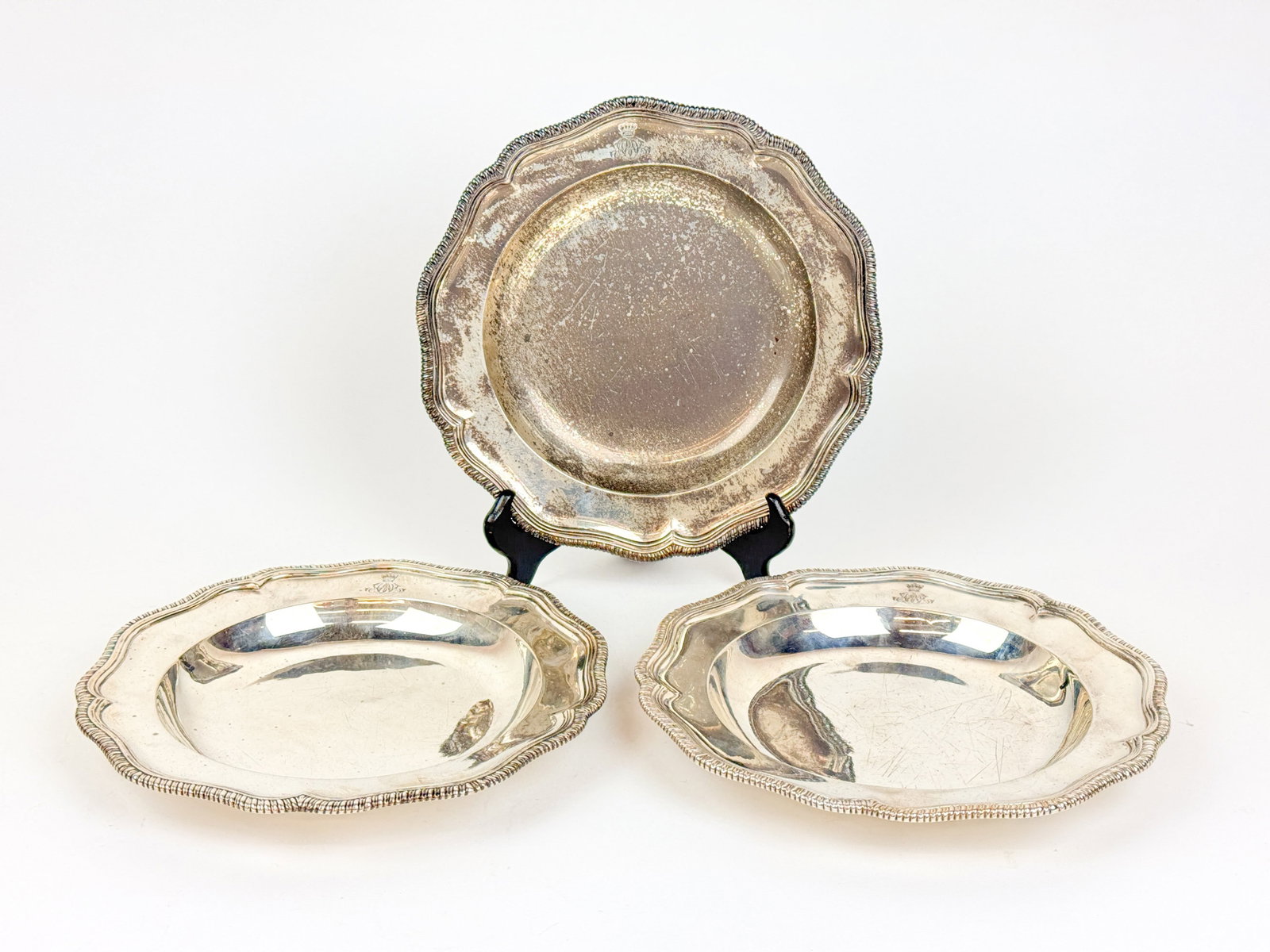 3 English George III sterling plates.: A group of three 1787 English George III sterling plates. Monogram under a crown. Royal cypher. English hallmarks for maker William Pitts and London 1787 assay. 52.93 ozt. 9 7/8" x 1 1/8".