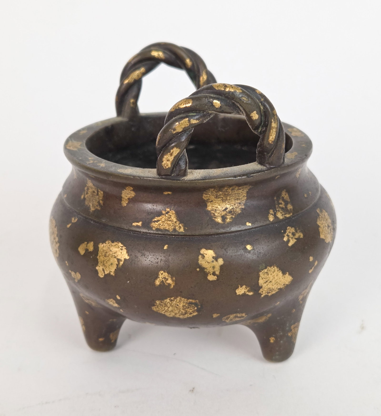 Japanese bronze censer.: A Japanese bronze censer with twisted upright handles and globular body on three feet. 20th century. Marked with apocryphal reign mark on bottom. 3 1/2" x 3 3/4" Provenance: From the Estates ofRaymond