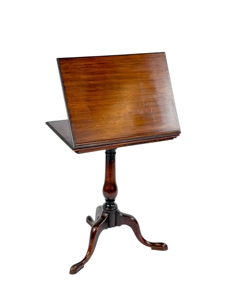 George III Mahogany Reading Table or Lectern,: late 18th/early 19th century. A mahogany reading table or lectern having a hinged rectangular top with molded edge and book-rest ledge, supported by a ratcheted adjustment mechanism and flanked by two