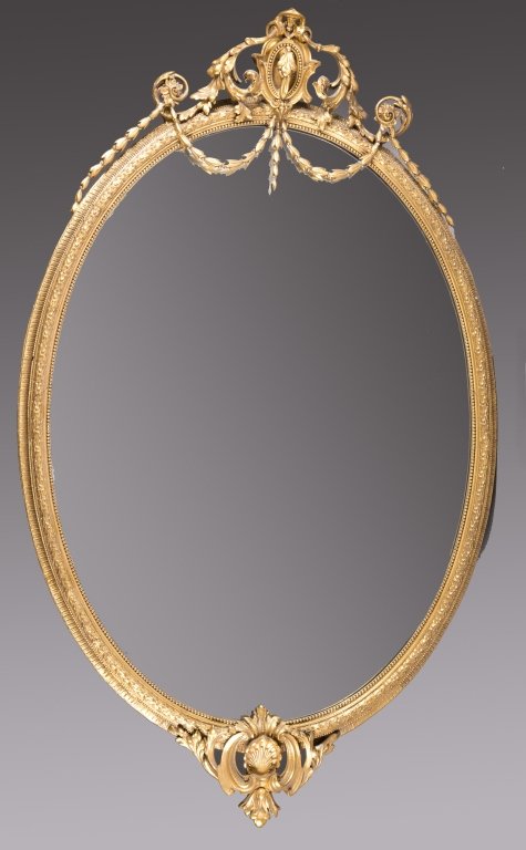 C. 1900 oval gilt frame mirror.: An oval gilt frame mirror with swag and garland molding. c.1900. Stamped, "John Taylor & Sons Manufacturer Edinburgh." 77 1/2" x 48 1/2".