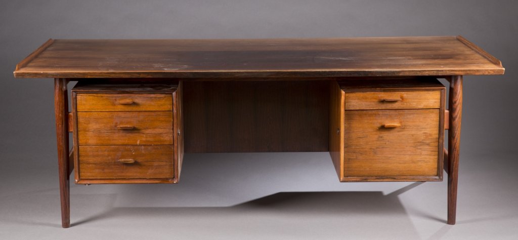 Arne Vodder Sibast rosewood desk.: A Danish rosewood writing desk designed by Arne Vodder. 3rd quarter 20th century. Made by Sibast. Desk having three drawers on the left side and two on the right. Maker's label underneath table. 29"h