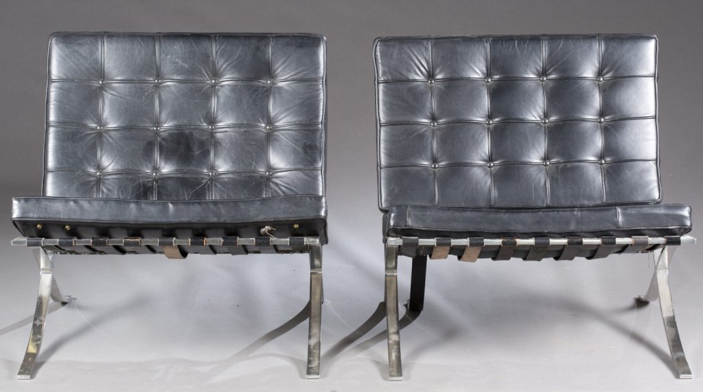 Pair of black leather Barcelona chairs.: A pair of Knoll Barcelona Chairs. 2nd half 20th century. Designed by Mies van der Rohe. Black tufted leather upholstery and steel frames. Original Knoll International sticker. 29 3/4"h x 29 1/4"w x 29