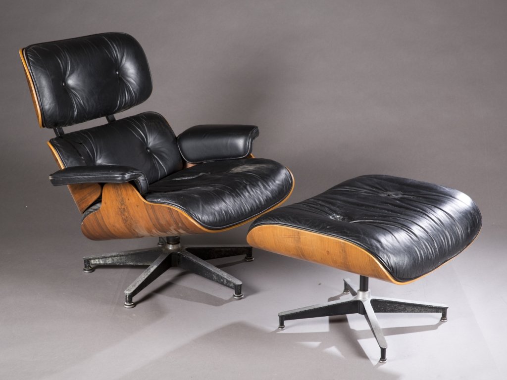 Eames lounge chair/ottoman/partial chair frame.: An Eames Lounge Chair with Ottoman and partial Lounge Chair Frame. 2nd half 20th century. ++ Lounge Chair and Ottoman black leather and molded and veneered plywood. Residue from where label was. Chair