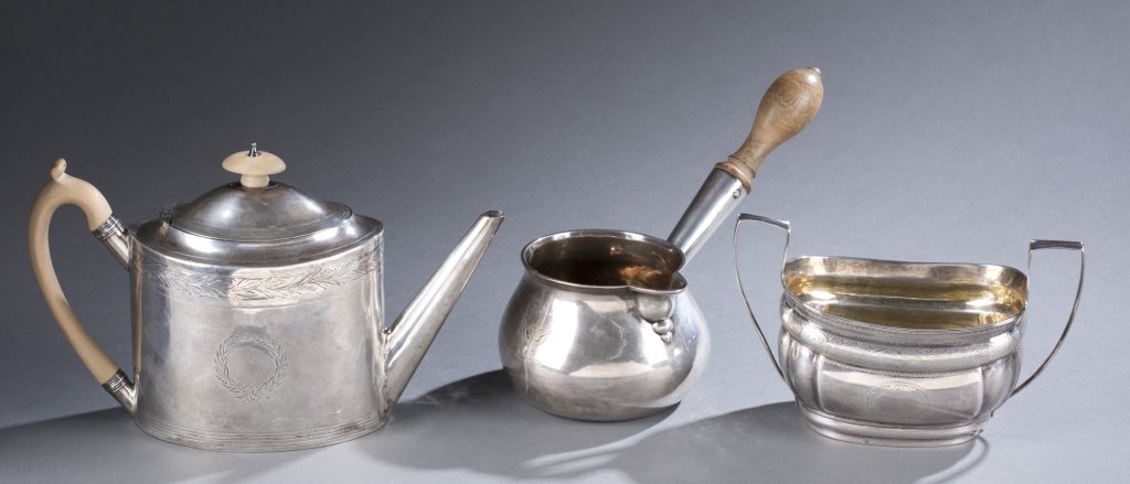 London Sterling teapot, bowl and pourer: A group of three George III London sterling hollowware pieces. ++ A teapot with incised decoration of wreath pattern and floral border. Hallmarked, 1796, with makers mark for Chawner & Eames. 61/2" x 